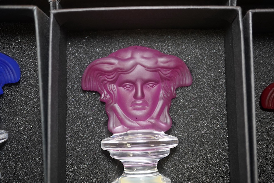 Seven boxed Rosenthal for Versace glass Medusa head wine bottle stoppers in various colours. Condition - good.